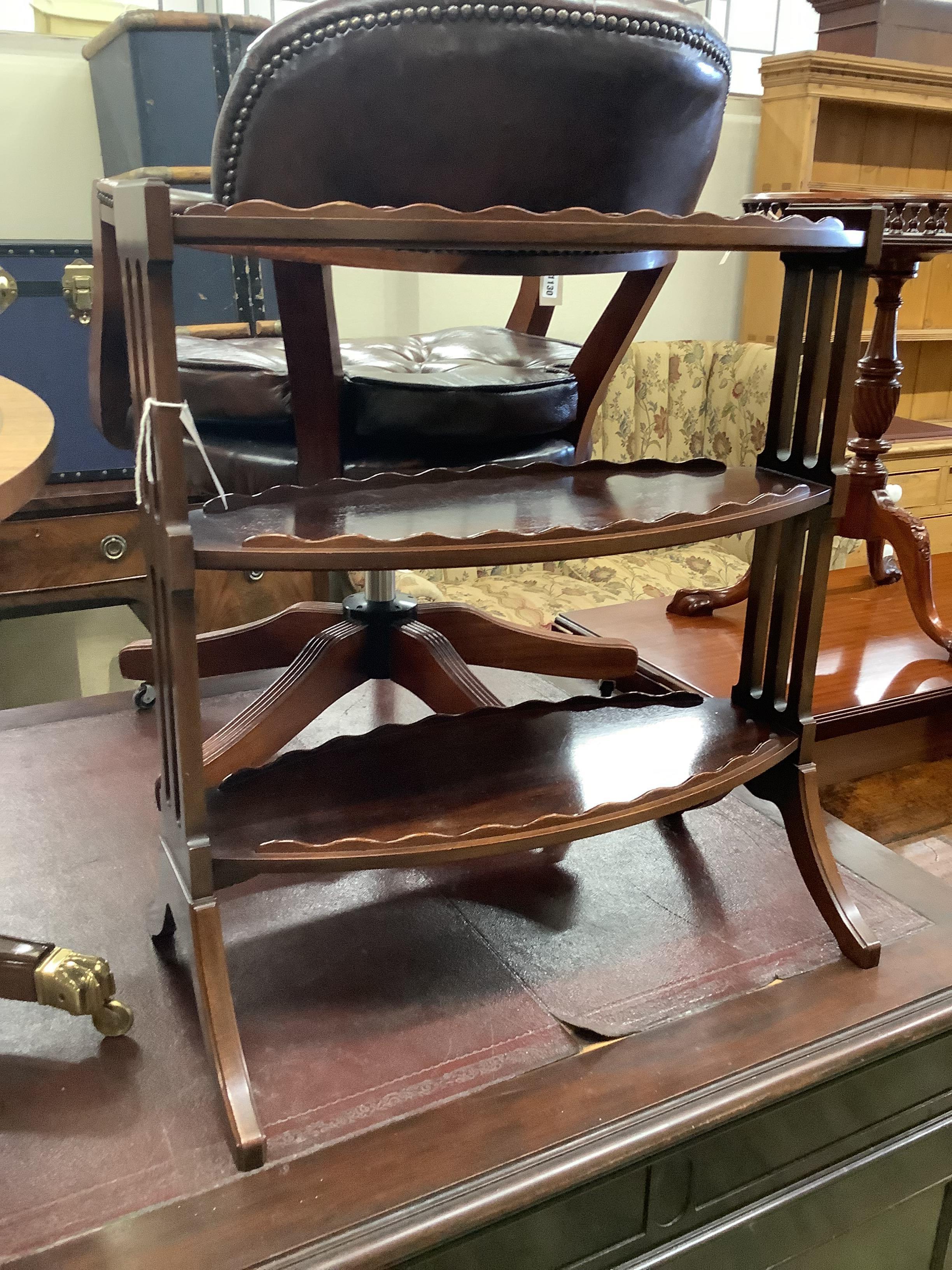 A reproduction low oval mahogany coffee table, length 120cm, depth 68cm, height 50cm together with an oval mahogany three-tier occasional table